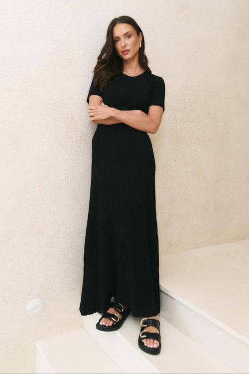 Model wearing a black knit dress