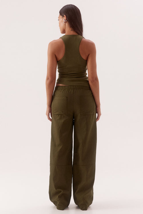 Person wearing a green jumpsuit on a white background