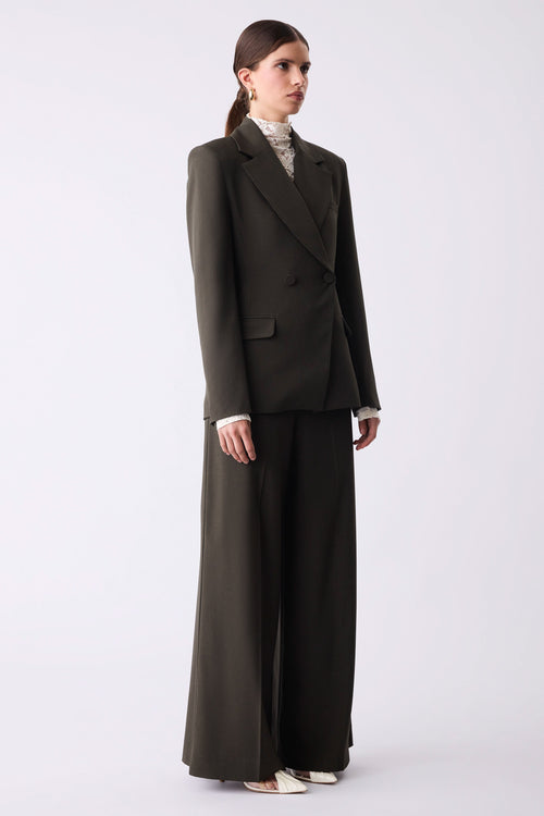 Woman wearing a dark gray suit on a white background