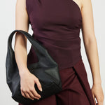 model holding black bag