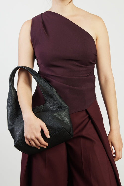 model holding black bag