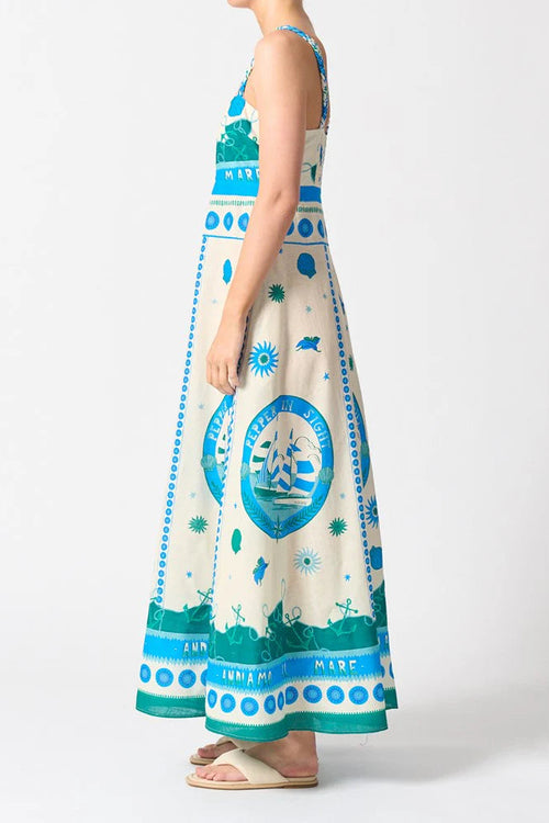 Woman wears a colourful blue strappy maxi dress