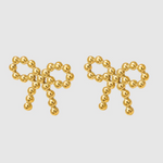A pair of delicate gold-toned stud earrings shaped like bows, crafted from small polished metal beads arranged in a symmetrical design