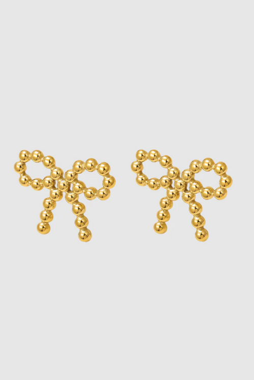 A pair of delicate gold-toned stud earrings shaped like bows, crafted from small polished metal beads arranged in a symmetrical design