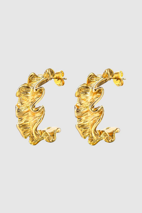A pair of gold-toned hoop earrings with a unique ruffled design, featuring a textured, wavy surface that mimics soft fabric folds for a sculptural, organic look.