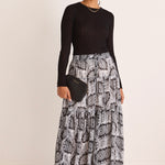 model wears a black print maxi skirt