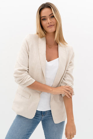 model wears a beige jacket