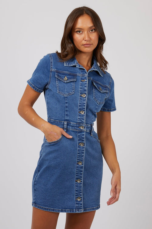 model wears a blue mini denim dress