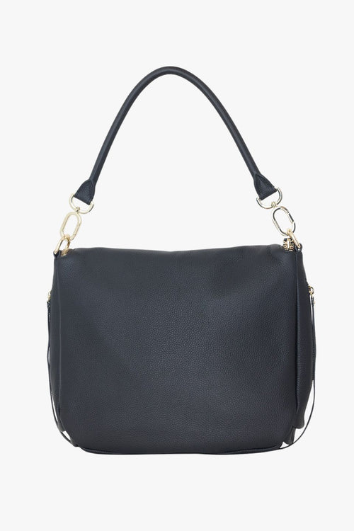 Angled front view of a black pebbled leather shoulder bag featuring a soft fold-over flap with gold zip detailing. The structured shape is complemented by gold hardware and a detachable top handle. The brand name 'SABEN' is embossed in gold at the base front of the bag.