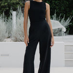 Woman wearing a black pant and black tank