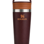 Stanley insulated travel tumbler with a dark burgundy body, a warm brown lid and carrying handle, and a silver stainless steel band around the middle.
