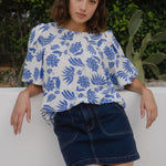 Woman wears a blue white floral blouse