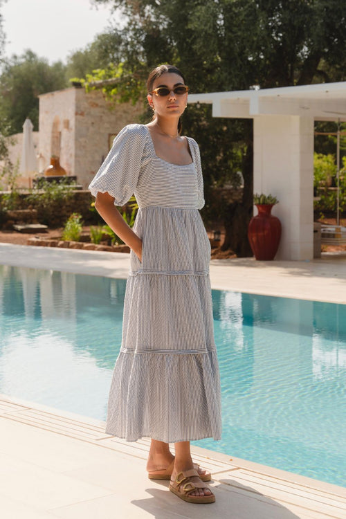 model wears a blue white stripe maxi dress