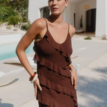 Woman wearing a brown ruffled dress 