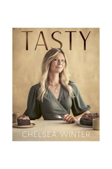 Book cover of 'TASTY' by Chelsea Winter, featuring a portrait of the author seated at a table with cakes and coffee against a warm beige background.
