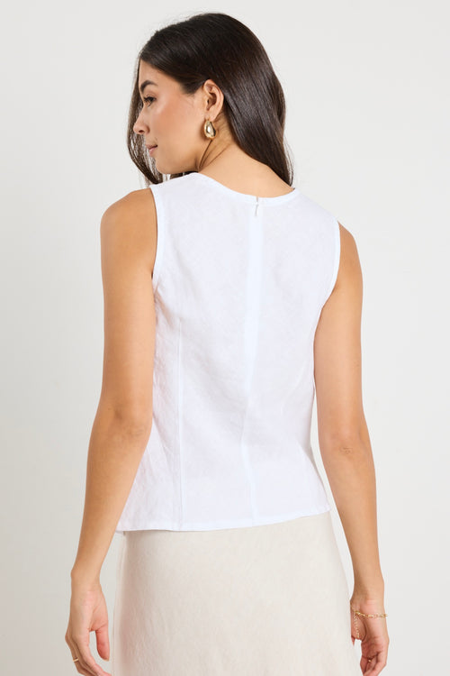 model wears a white linen tank top