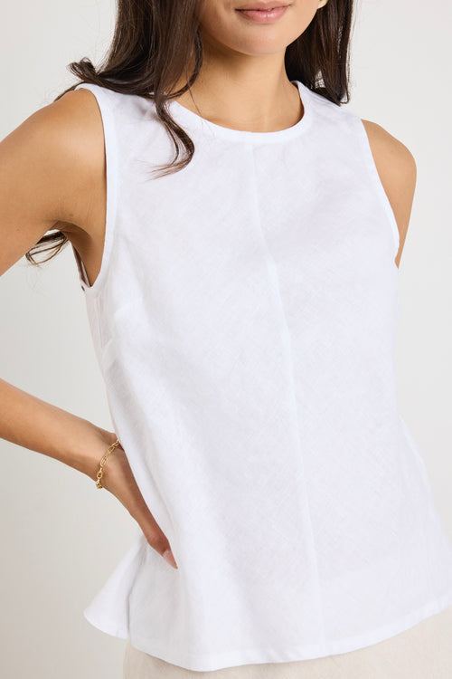 model wears a white linen tank top