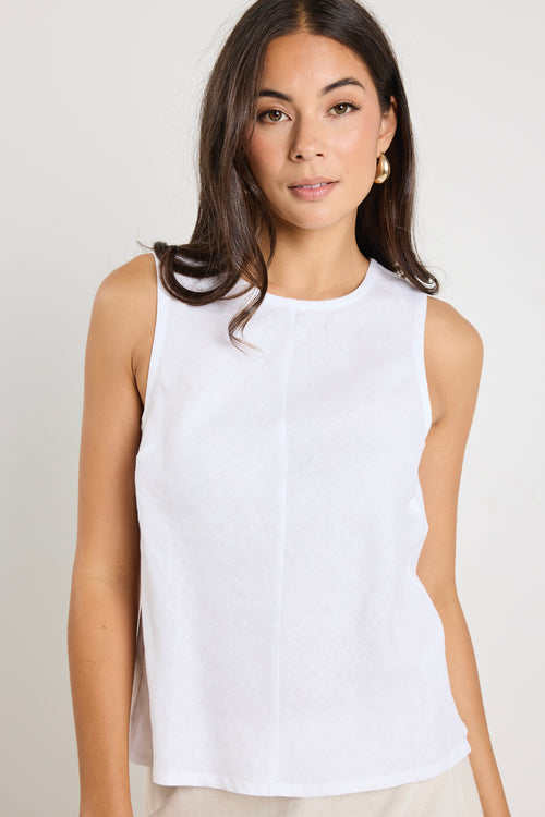 model wears a white linen tank top