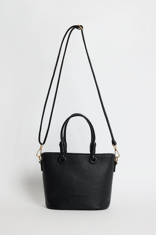 Small black PU leather handbag with knotted top handles and a long detachable shoulder strap, photographed against a plain light background