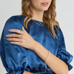 model wears Blue Satin Short Sleeve Top