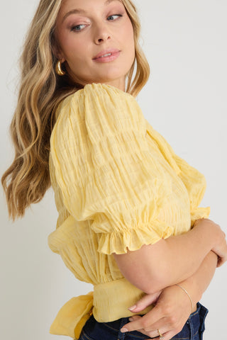 model wears a yellow puff sleeve top