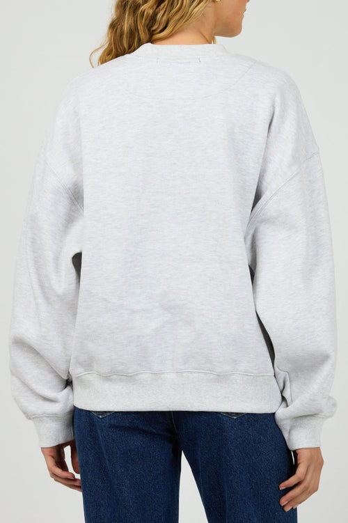 model wears a grey sweater