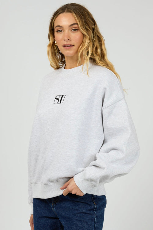 model wears a grey sweater