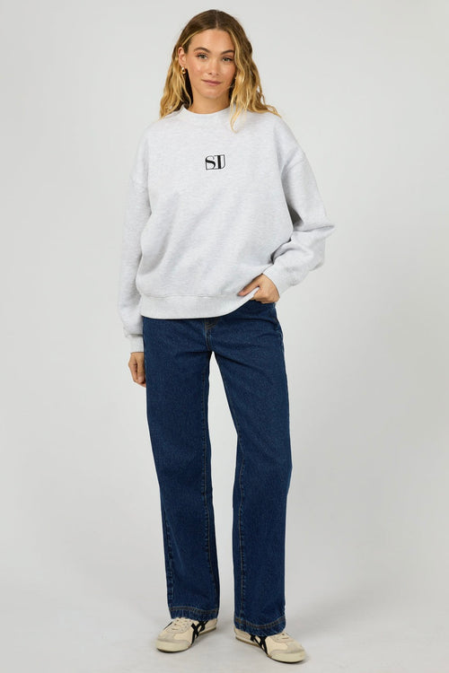 model wears a grey sweater