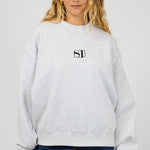 model wears a grey sweater