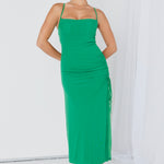 model wears a green maxi dress