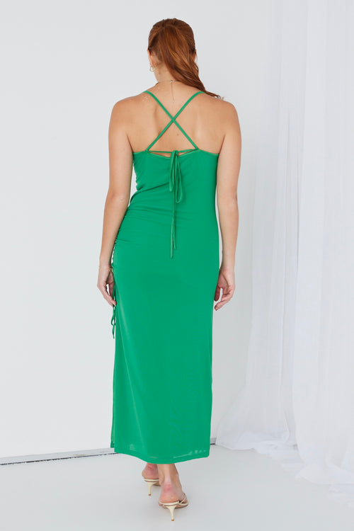 model wears a green maxi dress