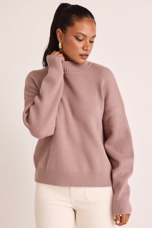 model wears a pink knit