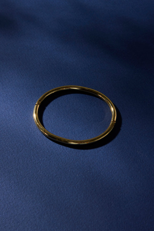 Gold ring on a blue fabric background