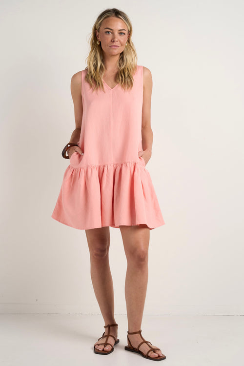 model wears a pink linen mini dress