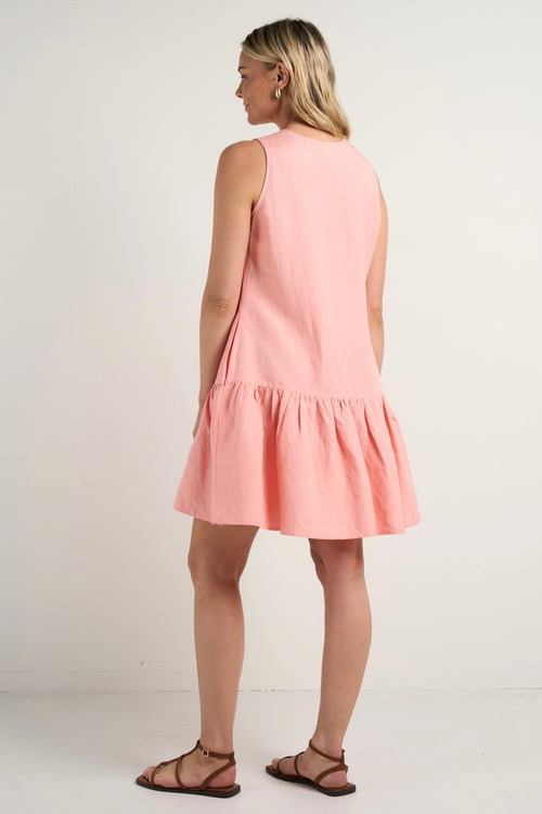 model wears a pink linen mini dress