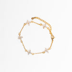 Gold bracelet with star-shaped charms on a white background