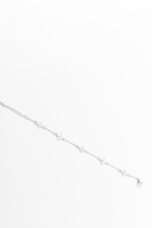 Silver bracelet with small stones on a white background