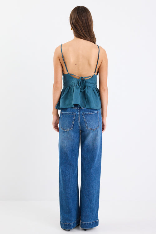 A forest green strappy cami top made from 100% linen, with a V-neckline and tie-back detail. Fully lined for comfort and breathability.