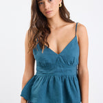 A forest green strappy cami top made from 100% linen, with a V-neckline and tie-back detail. Fully lined for comfort and breathability.