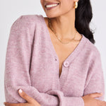 model wears a pink cardigan