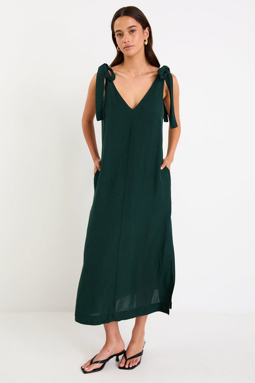 Model wearing a forest-green tie-shoulder midi dress with a relaxed fit and flowy skirt