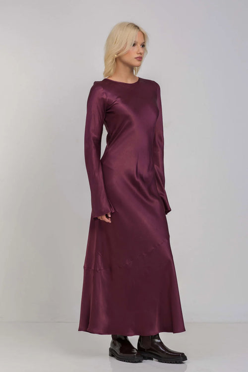 Model wears a plum Burgundy maxi long sleeve dress 