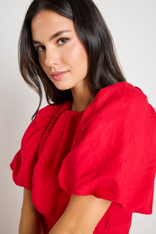 model wears a red cherry maxi dress