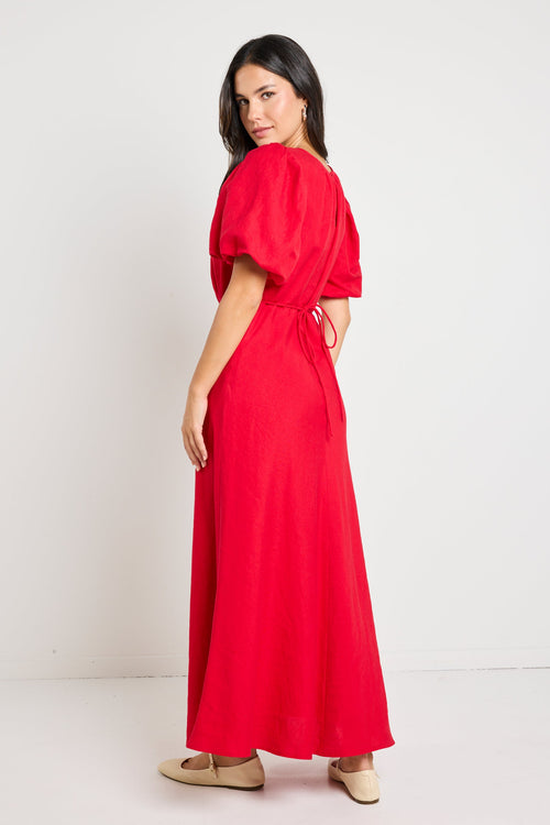 model wears a red cherry maxi dress