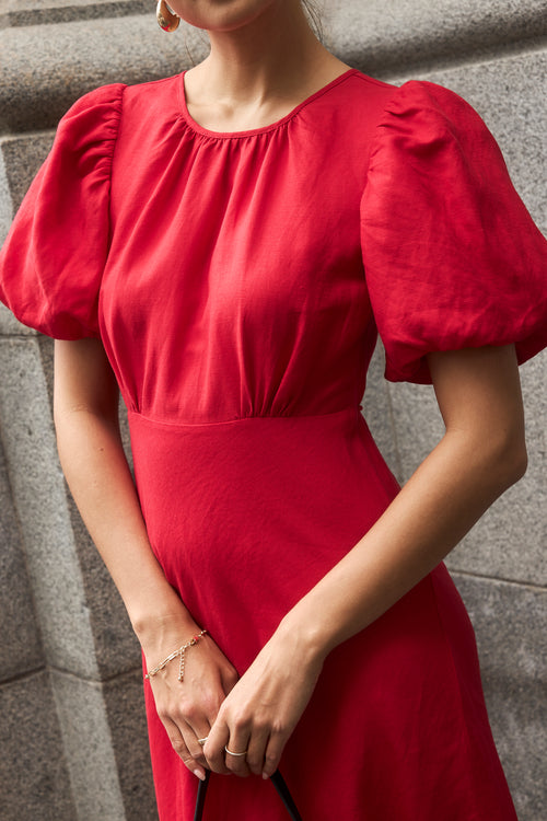 model wears a red cherry maxi dress