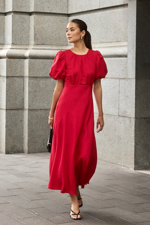 model wears a red cherry maxi dress