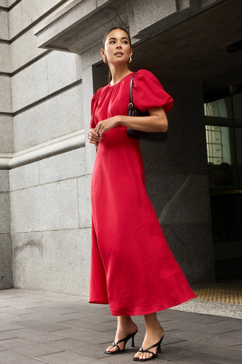 model wears a red cherry maxi dress