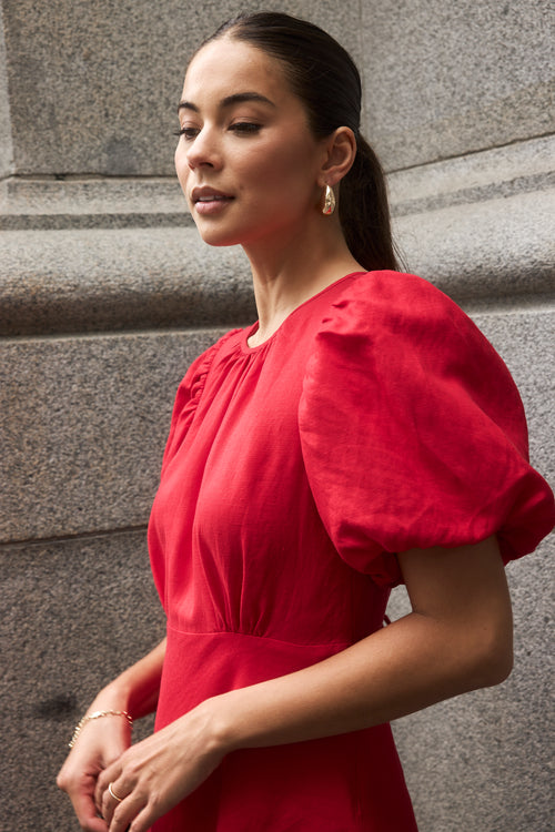 model wears a red cherry maxi dress