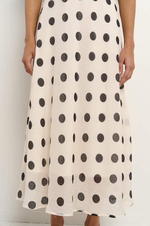 model wears a cream puff sleeve polka dot maxi dress