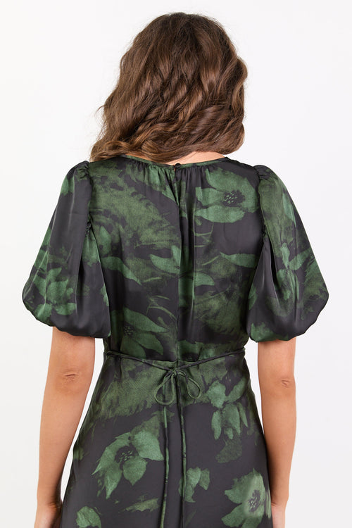 Green and black floral patterned dress on a white background